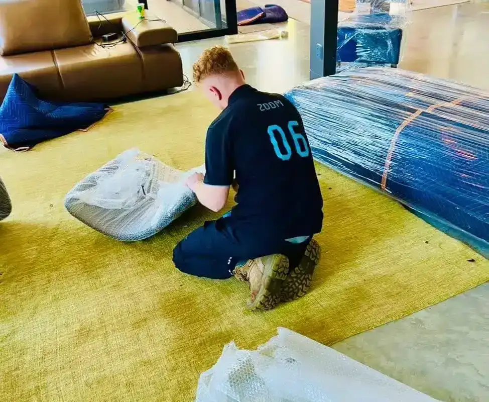 777 World Removals crew wrapping furniture before a move